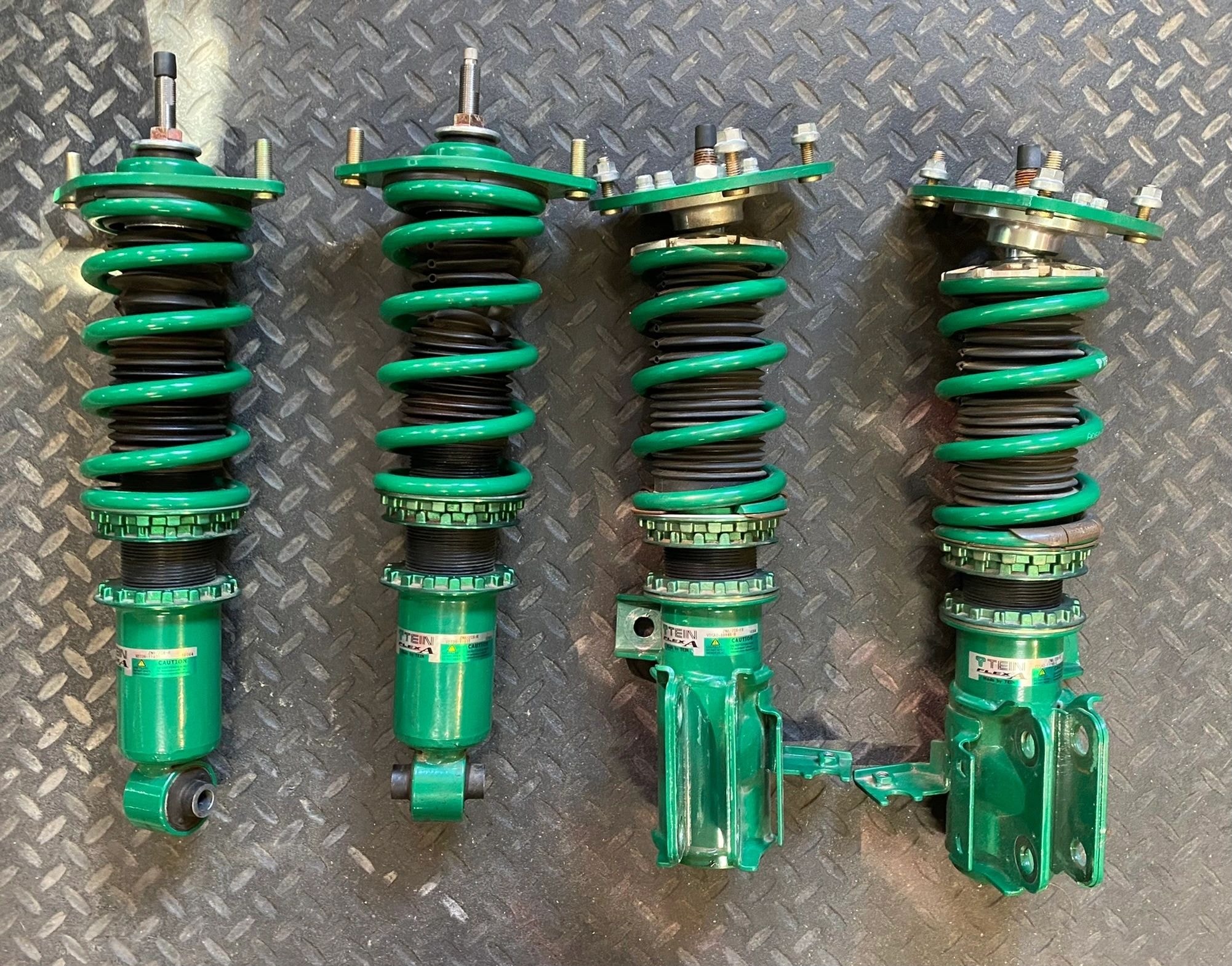 Coilover suspension parts on diamond plate